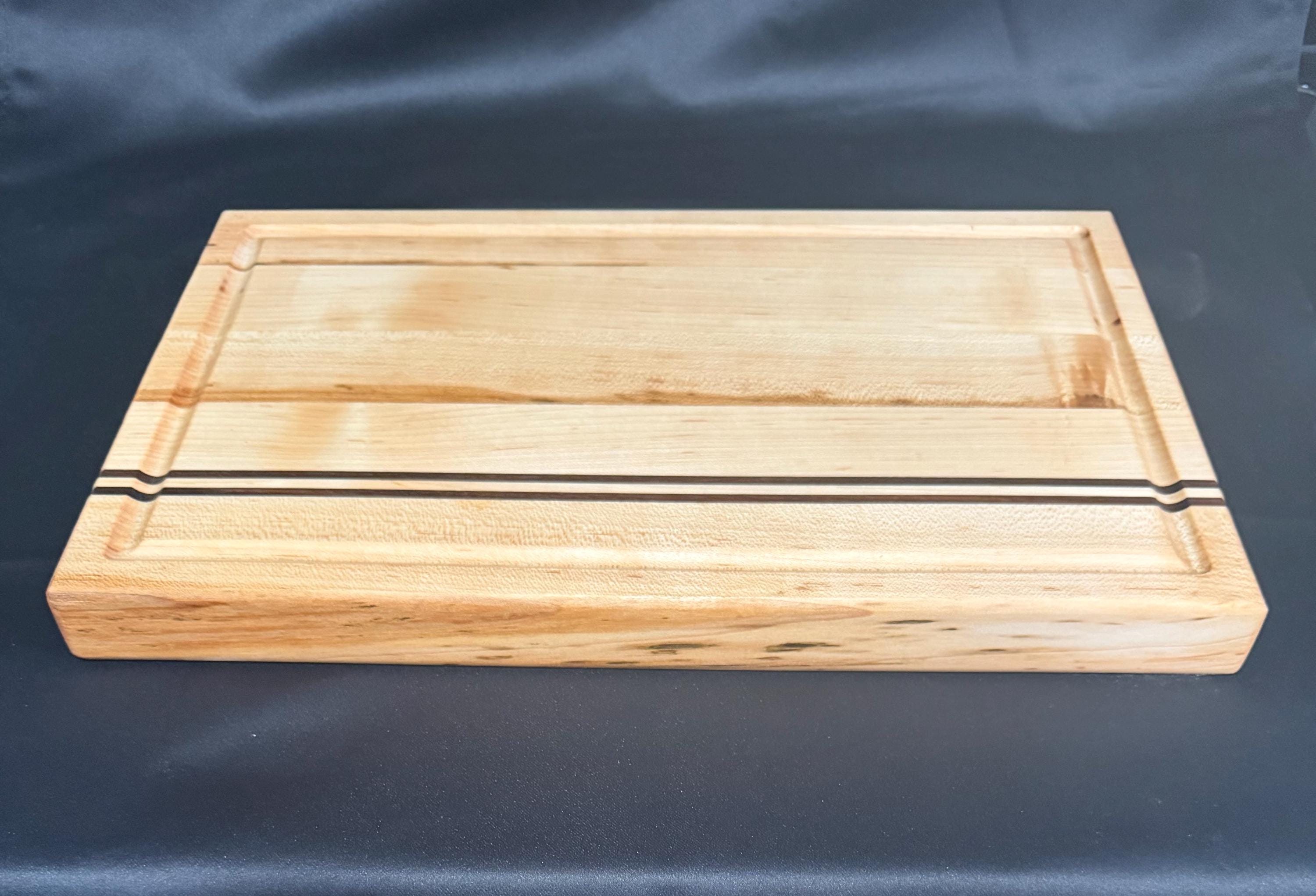 Handmade Maple cutting board with a walnut stripes.